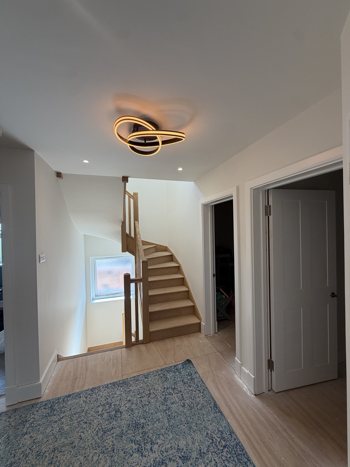 Freshly decorated landing with pale walls and white door frames